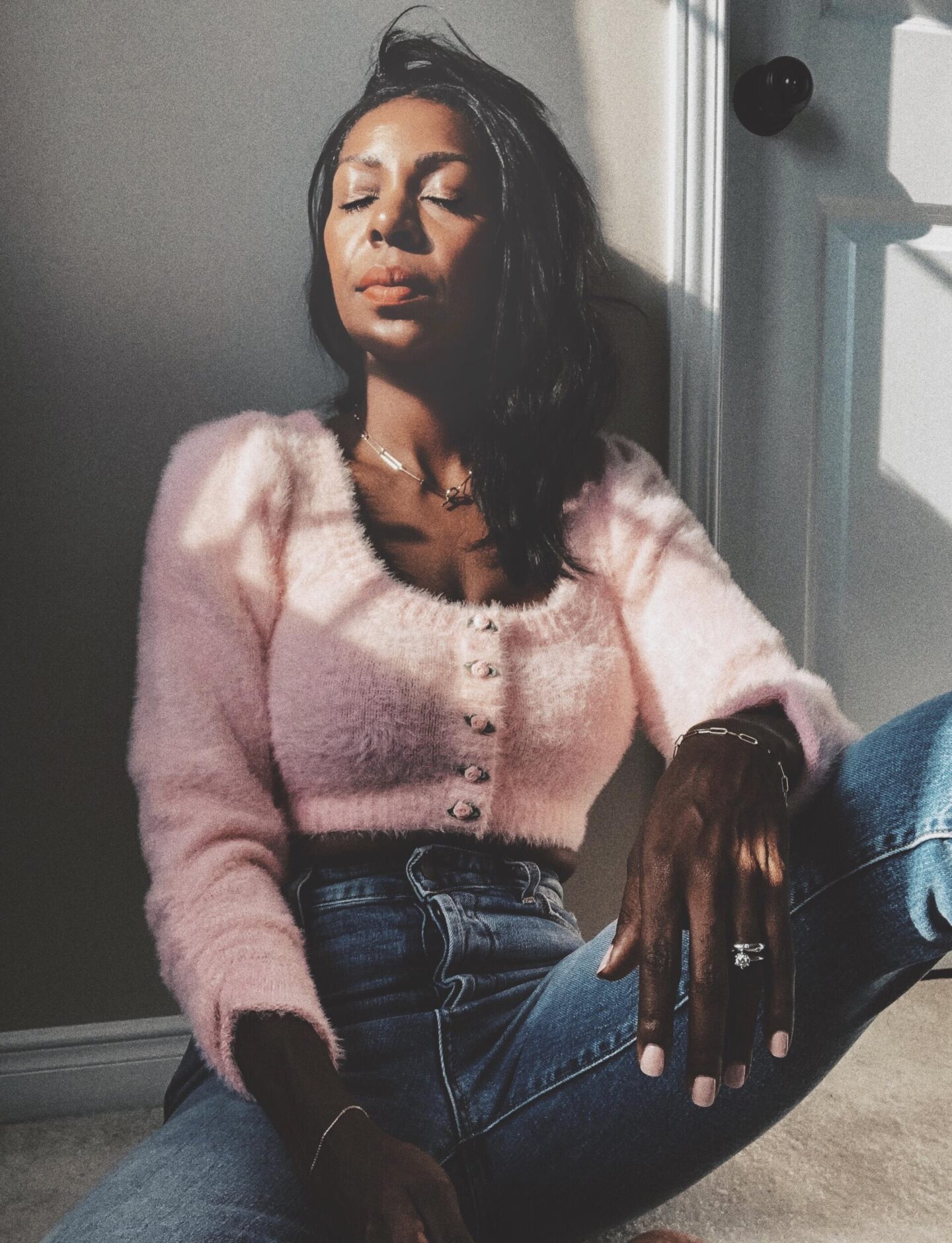 Dominique Baker in pink cropped sweater